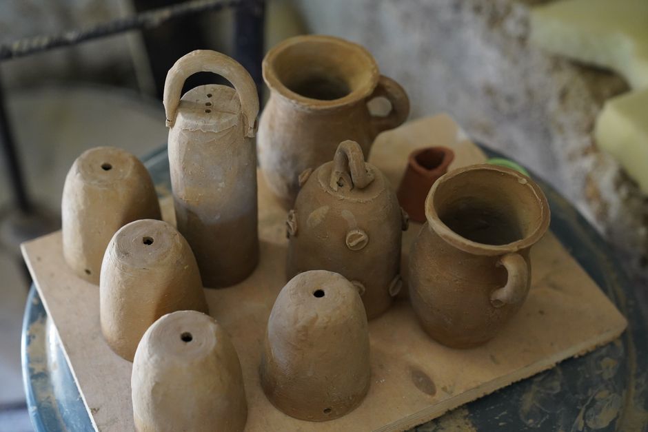 Collection of handcrafted clay pots in a traditional pottery workshop, showcasing artisanal craftsmanship.